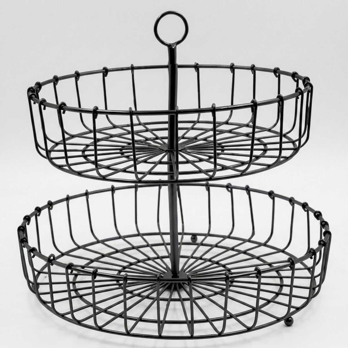 A two-tier black metal wire serving basket with a central handle, shown against a light gray studio background