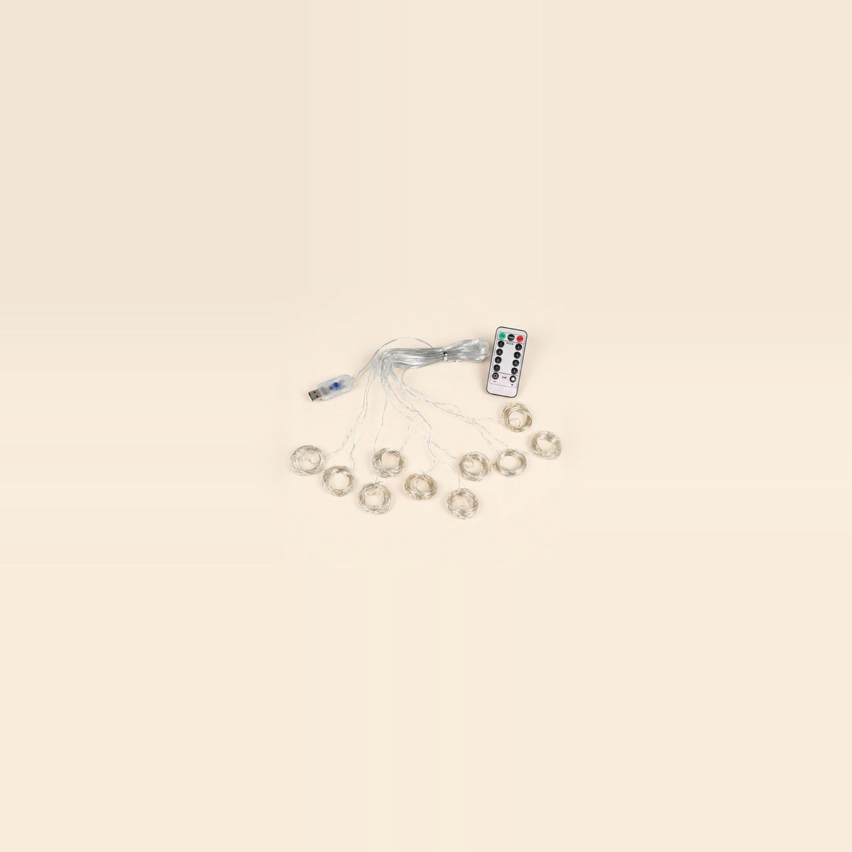 An LED curtain light with coiled clear strands, a USB controller and a white remote sits centered against a spacious