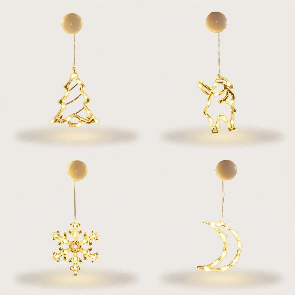 Four illuminated clear ornaments shaped as a Christmas tree, Santa, snowflake, and crescent moon hang beneath round cream
