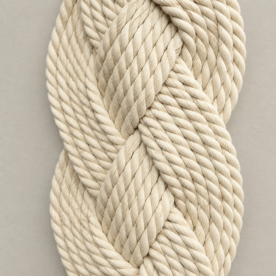 Macro of the plaited rope showing the twist of each ply, plaited rope column in cream