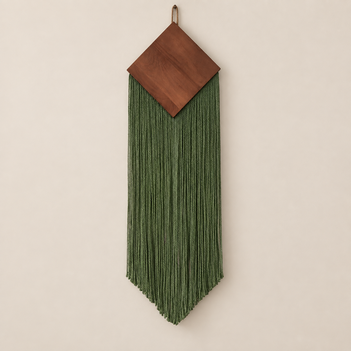 Green studio on cream, wood diamond over a narrow chevron fringe