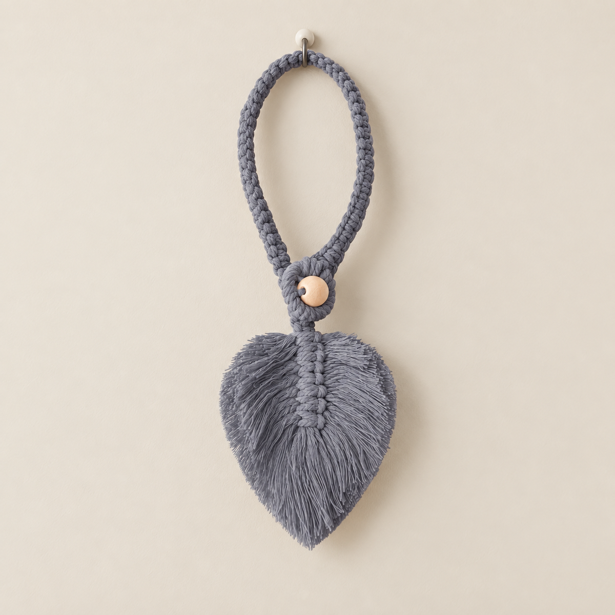 Gray studio on cream, macrame leaf holdbacks in 6 colors, twisted cord, combed flat at the leaf, round pale wooden bead