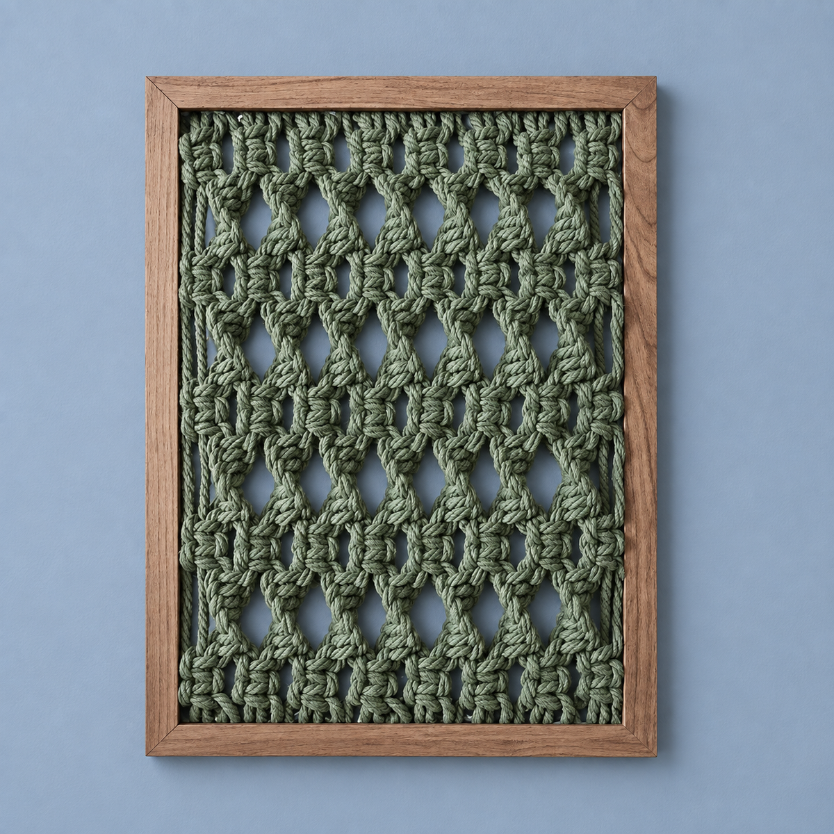 Three frames above a bed, cream and green, macrame panel in 13 knot styles