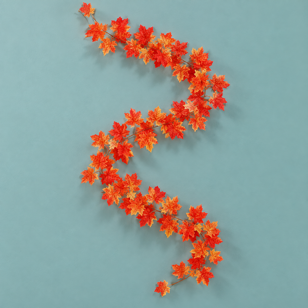 A single 230 cm maple leaf vine laid in an S curve on a teal background