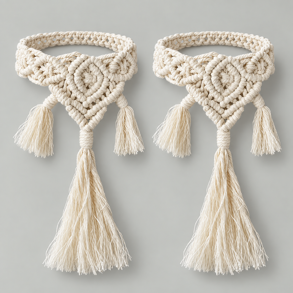 Two knotted macrame curtain tie backs with diamond motifs and three tassels each