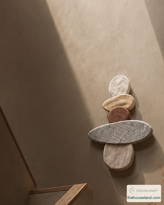 [thehouseland] best wabi sabi wall art - Close view of a stacked totem of five smooth stone-effect pebbles in graded greys and warm sand, balanced one