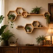 Hexagonal wooden wall shelves mounted on a beige wall above a dark wood console table, styled with potted green plants, books, candles, and decorative vases in a warm, cozy interior setting.