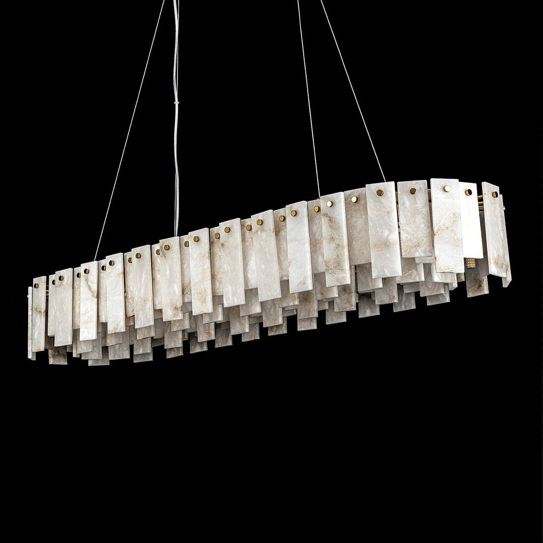 Unlit linear pendant light with staggered white and gray alabaster panels and round gold fasteners against a black background.