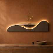Mocha / Wave backlit curved wall panel with shelf and glass bud vase, warm LED backlight on