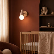 Vanity Sconce with Exposed Globe Bulb, Adjustable Iron Wall Lamp, 5 Colors in a nursery