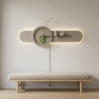 Sage oval backlit wall panel shown powered on with its cord routed to a wall outlet