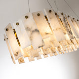 Pendant light with staggered cream alabaster panels, gray veining and round gold-colored fasteners against a pale background.