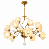 A multi-light floral chandelier with a gold-finished metal frame, featuring multiple warm white flower-shaped glass shades and a hanging crystal drop, shown against a plain white background.