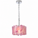 A modern pendant light with a polished chrome chain and ceiling canopy, featuring a fluted, translucent pink glass shade that glows with a warm light from within.