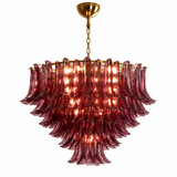 A multi-tiered Murano-style glass chandelier with fluted, petal-like glass shades in a translucent burgundy red, suspended from a polished gold brass chain and canopy against a solid white background.