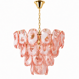 A modern multi-light chandelier featuring wavy, translucent pink glass shades with gold-finished metal hardware, including a ceiling canopy and chain.