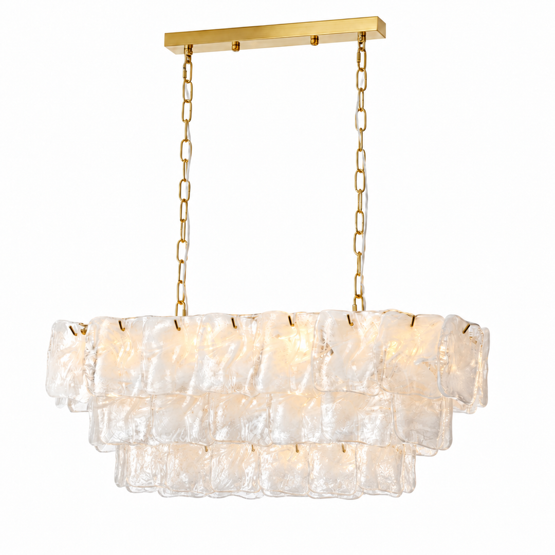 Linear chandelier with three tiers of pale textured glass, gold-tone chains, and a matching canopy against a white background.