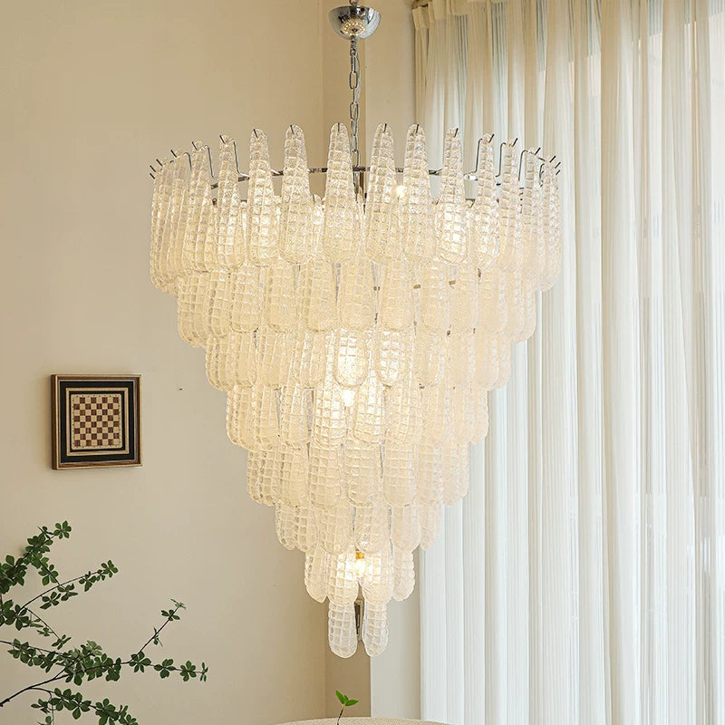 Chandelier hanging in a room with a window and plant
