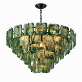 A modern multi-tier chandelier featuring textured, hand-blown green glass panels that glow warmly from within, suspended by a black chain from a matching black ceiling canopy, set against a plain white background.