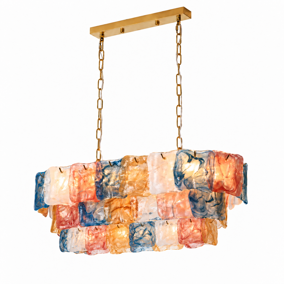 Linear chandelier with tiered pink, blue, amber and white textured glass panels, gold-toned chains and a matching canopy against a white background.