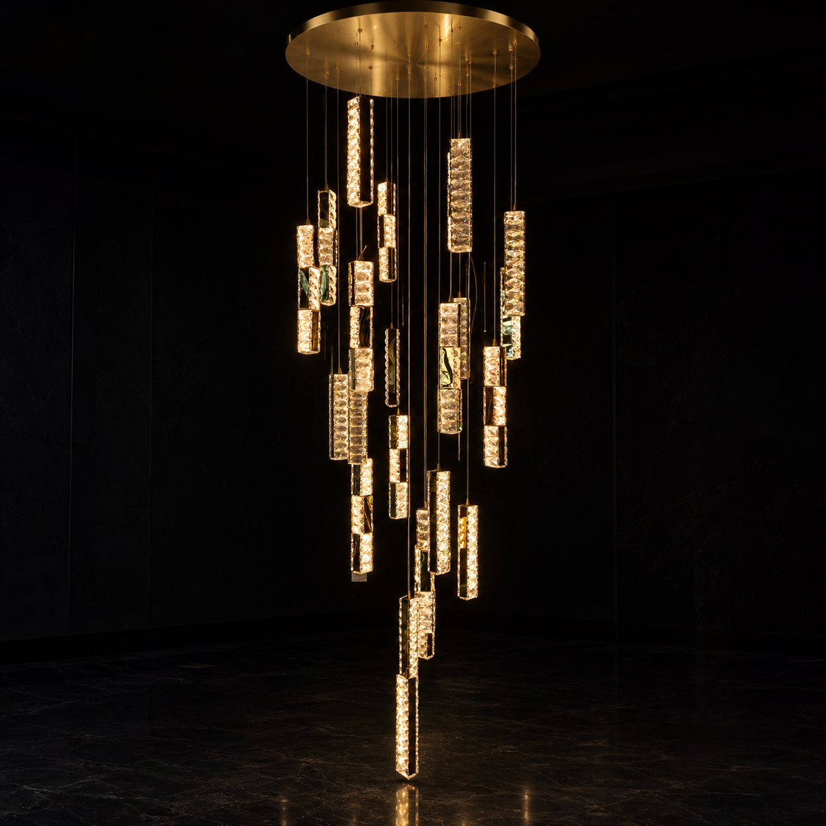 A modern multi-tier chandelier with a circular gold ceiling canopy, featuring numerous vertical crystal-encrusted tubes in varying lengths that dangle in a cascading arrangement against a dark background.