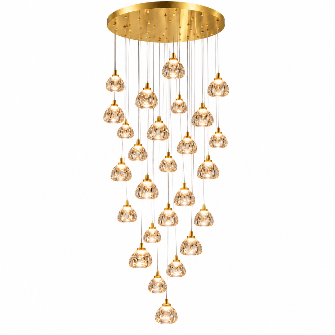 A modern multi-light chandelier with a brushed gold circular ceiling canopy, multiple gold-finished downrodents, and clear faceted glass pendant globes arranged in a cascading drape, shown against a plain white background.