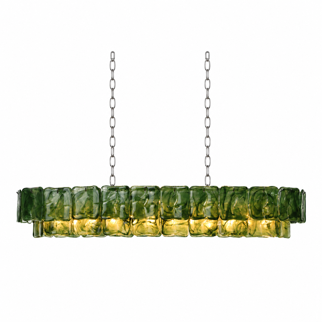 A linear chandelier with rippled green glass panels and silver-toned chains glows yellow against a white background.