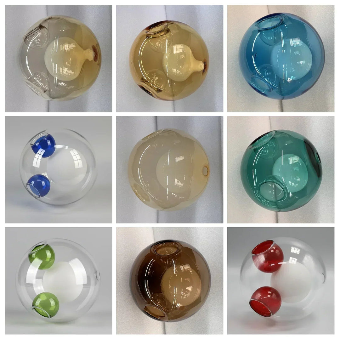 Nine chandelier glass globes in amber, blue, teal and clear finishes appear in a grid, some with contrasting colored openings.