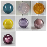 Seven chandelier glass globes in teal, pale pink, amber, yellow and purple shades appear against light gray backgrounds.