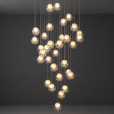 Modern chandelier with multiple spherical bulbs on a dark background