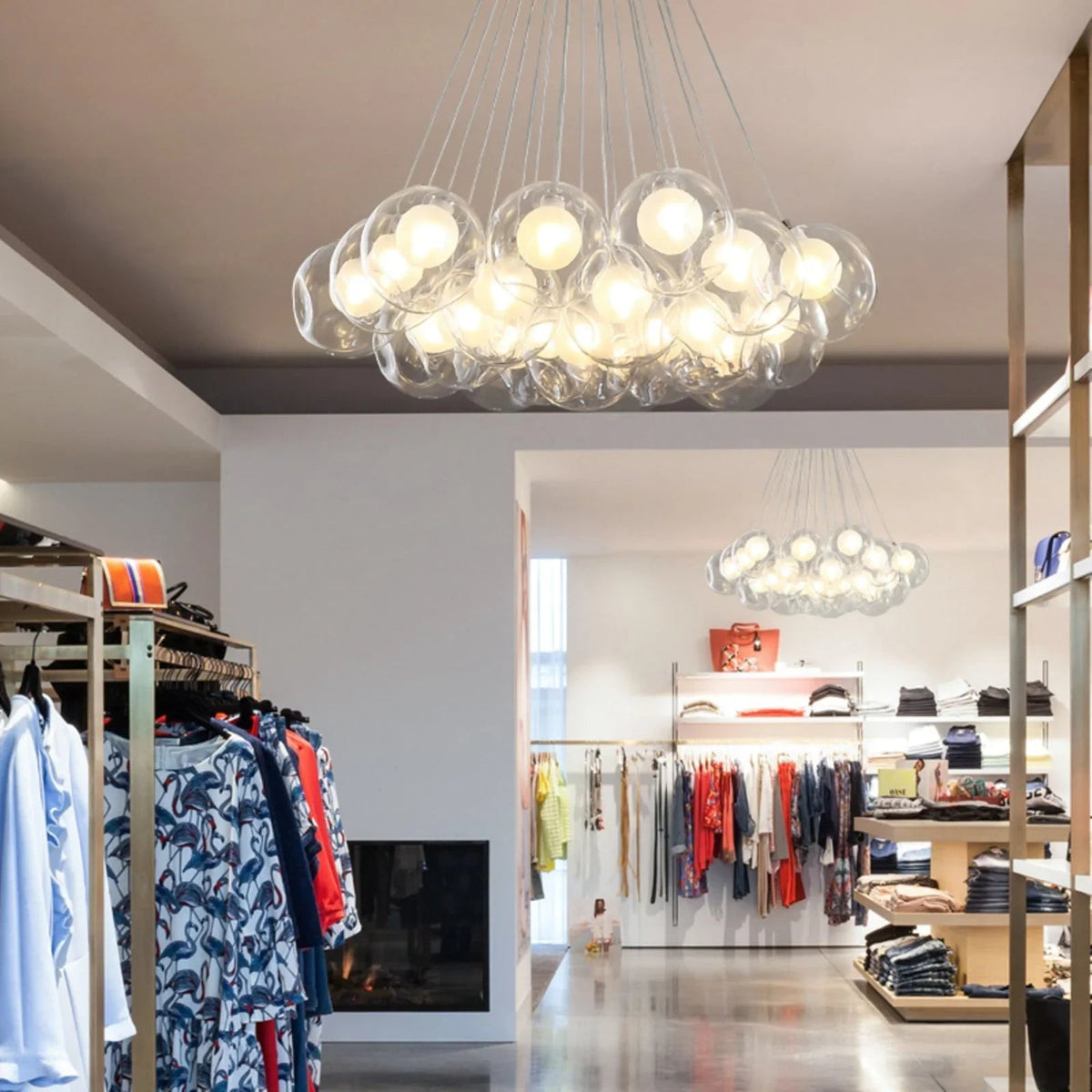 Modern clothing store interior with a large bubble chandelier.