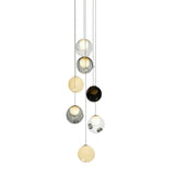 Seven-globe chandelier with clear, smoky gray, and pale yellow glass spheres hanging at staggered heights against a white background.