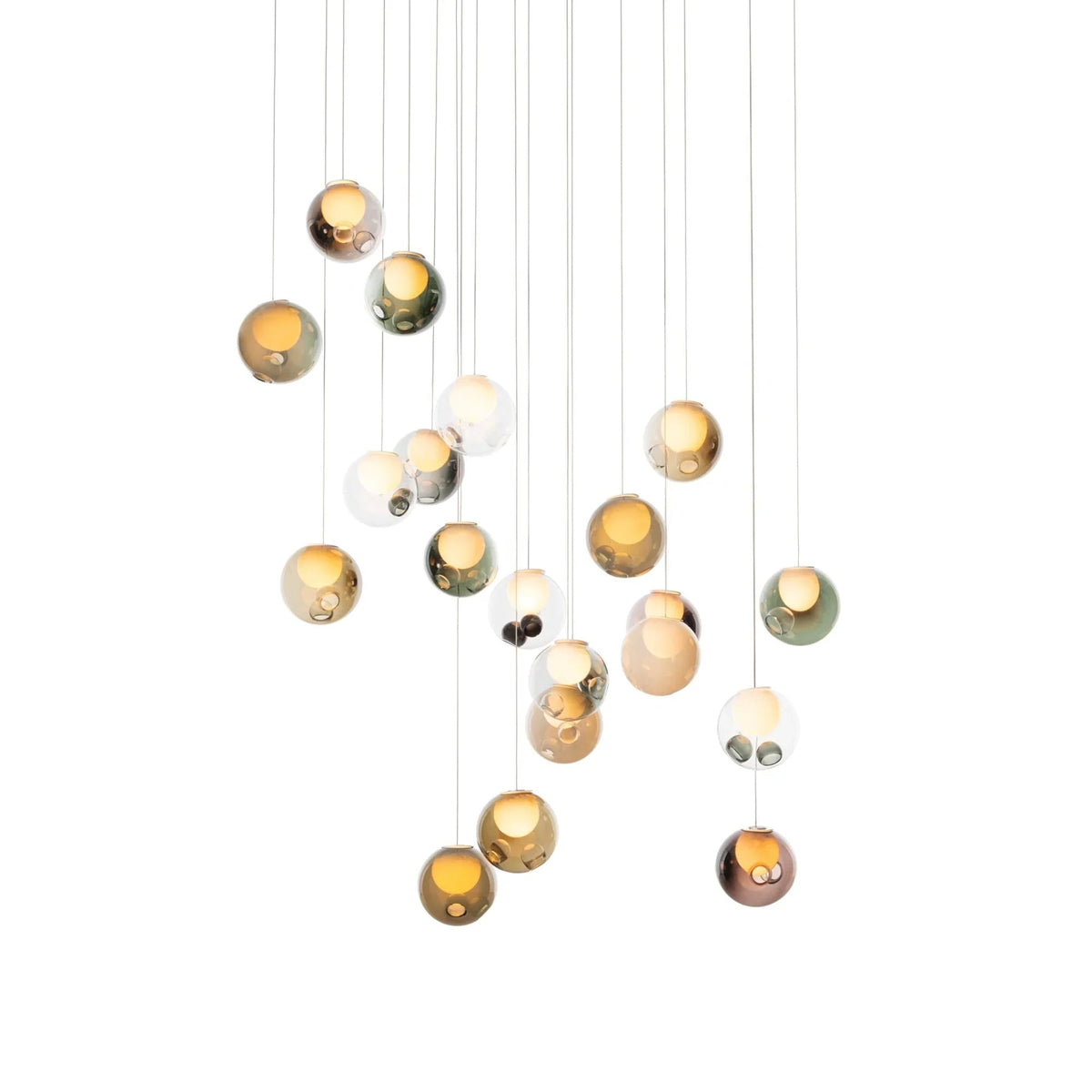 A chandelier with glowing glass globes in amber, green, pink, and clear finishes hangs at staggered heights against white.