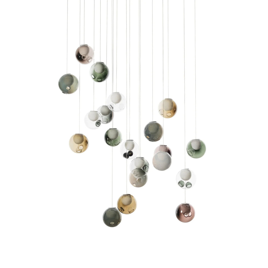 Chandelier with clear and muted colored glass globes suspended at varied heights in a broad cluster against a white background.