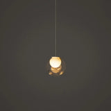 Single-light chandelier with a clear glass globe and glowing cream-colored inner shade hangs against a dark gray background.