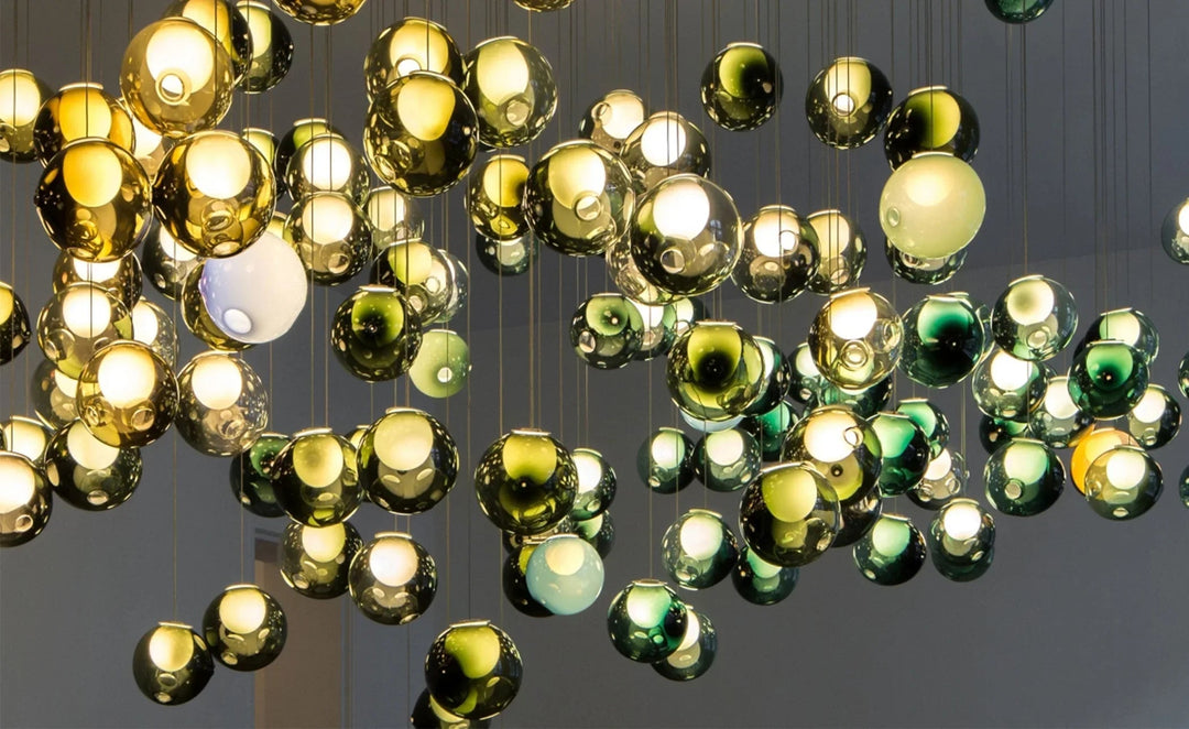 Chandelier with gold and green glass balls on a dark background