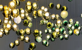Chandelier with gold and green glass balls on a dark background