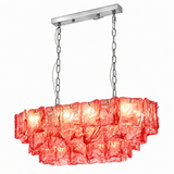 Linear chandelier with three tiers of red textured glass and silver-tone suspension chains against a white background.