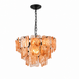 A modern multi-light chandelier featuring textured, irregular amber-orange glass shades suspended from a black metal frame and chain.