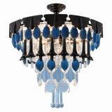 A semi-flush mount chandelier featuring a black metal frame, blue glass teardrop pendants, and cascading clear crystal drops on a white background.
