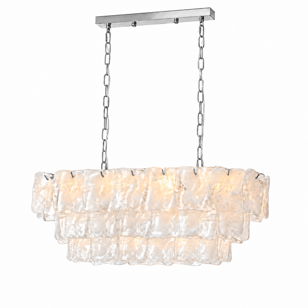 Linear chandelier with three tiers of pale textured glass, silver-tone chains, and a matching canopy against a white background.