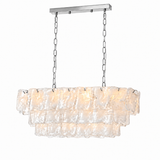 Linear chandelier with three tiers of pale textured glass, silver-tone chains, and a matching canopy against a white background.