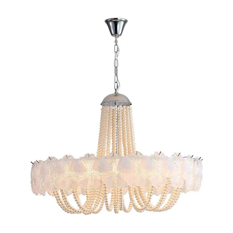 Illuminated chandelier with pale textured glass panels, draped clear bead strands, and a silver chain suspension against a white background.