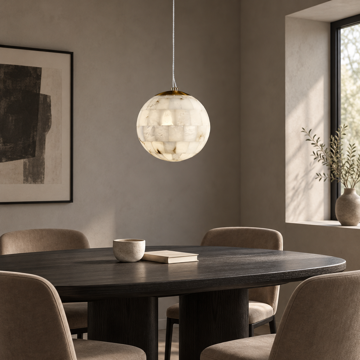 A spherical pendant light with a textured, translucent off-white glass or shell-like body hangs above a dark wood dining table with upholstered chairs in a softly lit modern room.