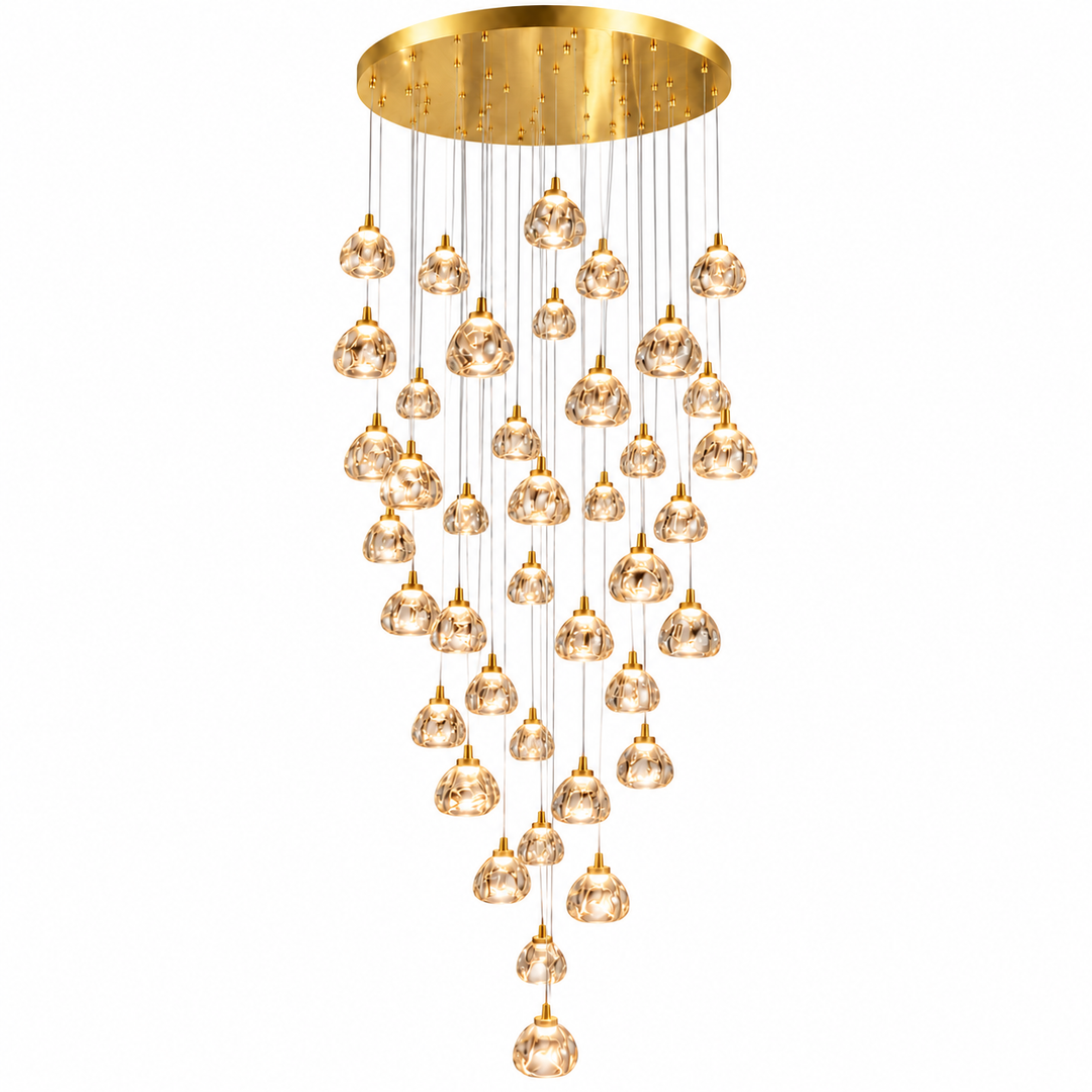 A modern multi-light chandelier with a brushed gold circular ceiling canopy and multiple clear faceted glass pendant globes hanging in a cascading arrangement against a white background.