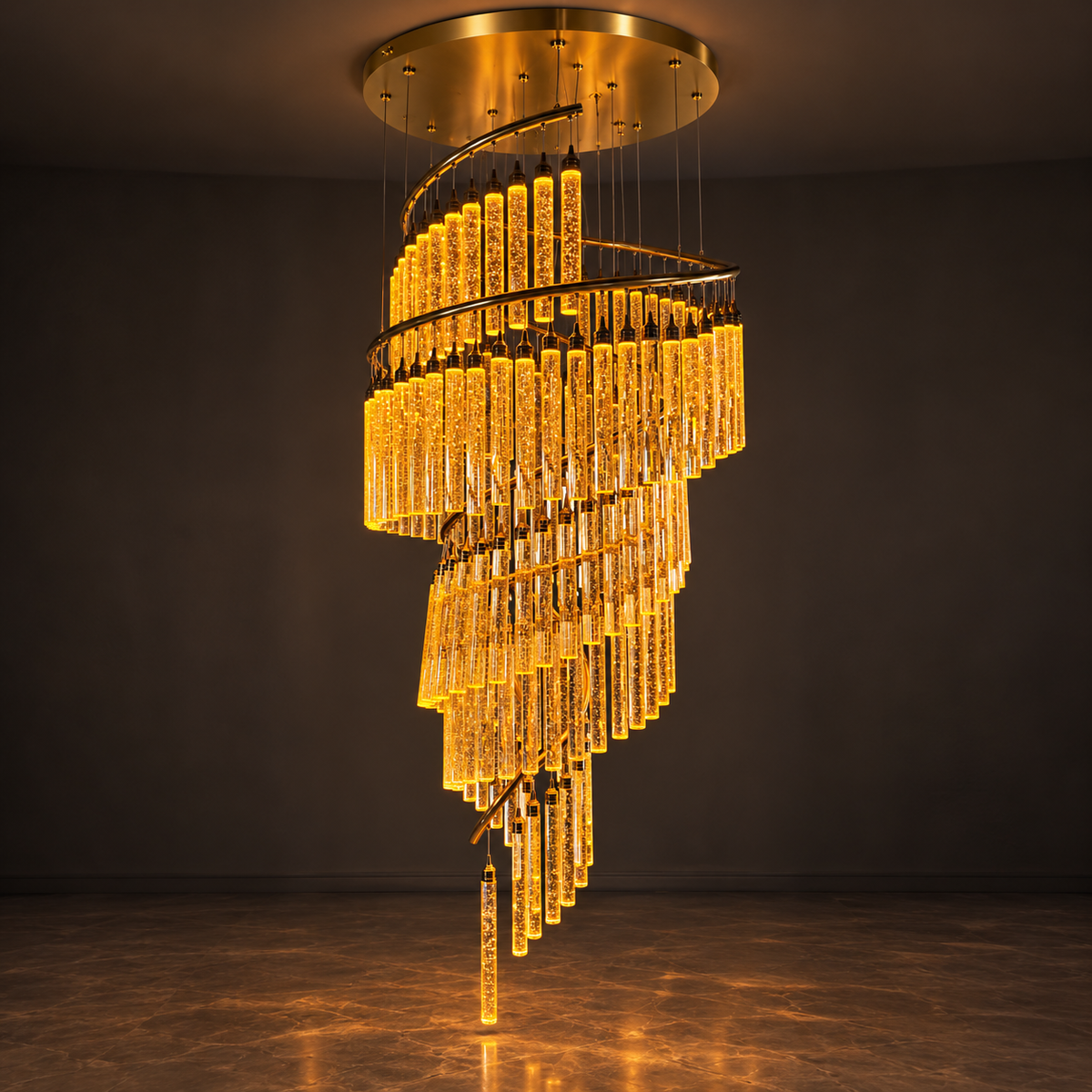 A modern spiral chandelier with clear glass tubes that glow warm yellow when lit, suspended from a circular gold ceiling mount in a dark room.