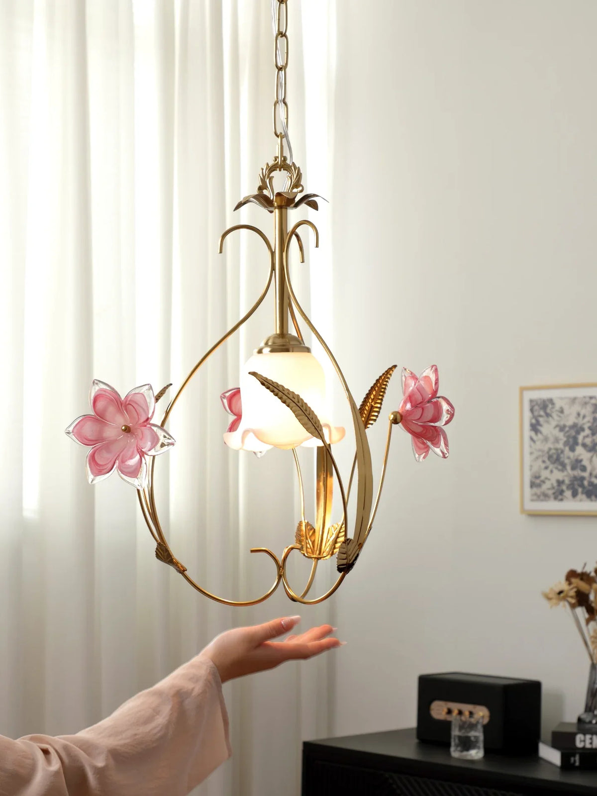 Decorative pendant light with floral design on a neutral background
