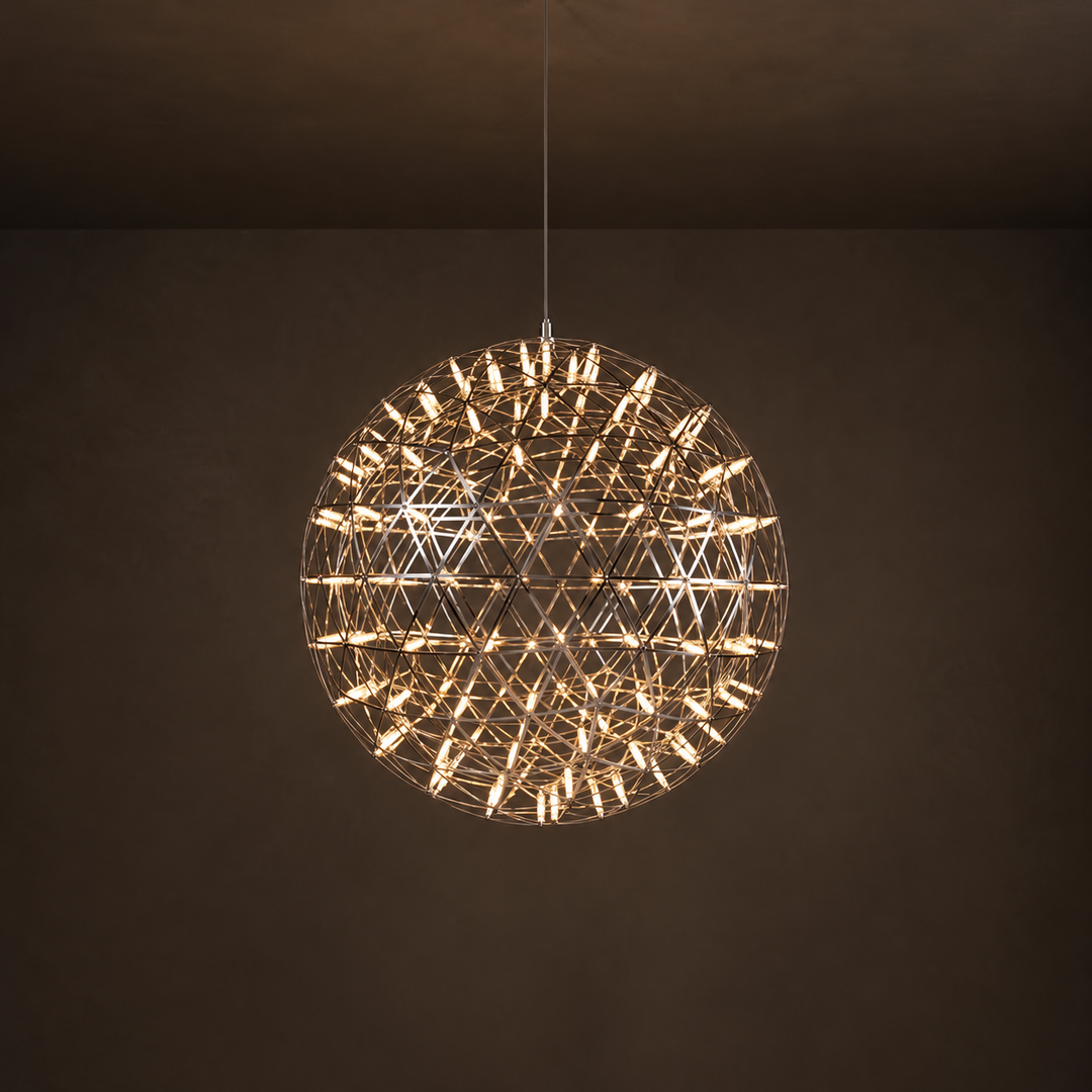 Globe pendant light with an open geometric metal frame and warm glowing tubes hangs against a dark brown background.
