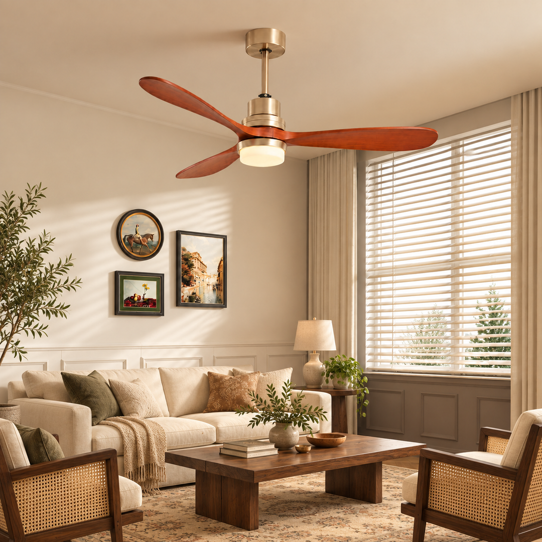A ceiling fan light with three reddish-brown wood blades and a gold-tone housing hung in a warm, neutral living room.