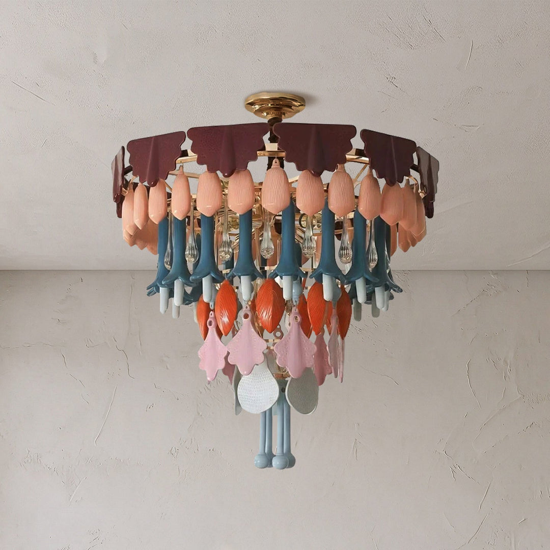 Round chandelier with burgundy scalloped pieces and peach, blue, orange, and clear glass drops against a white ceiling.
